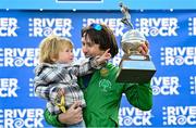 3 October 2021; Mick Clohisey of Raheny Shamrock AC, Dublin, celebrates with his son Paul, age 2, and his trophy after winning the 2021 Deep RiverRock Belfast City Marathon at Ormeau Park in Belfast. Photo by Ramsey Cardy/Sportsfile