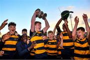 3 November 2021; Edward Nuzum of The King's Hospital celebrates with the trophy alongside team-mates after their side's victory in the Father Godfrey Cup Final match between St Fintan's High School and The King's Hospital at Energia Park in Dublin. Photo by Seb Daly/Sportsfile