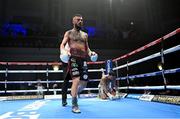 5 November 2021; Lewis Crocker knocks down Artem Haroyan in the seventh round during their WBO European welterweight title boutat the Ulster Hall in Belfast. Photo by Ramsey Cardy/Sportsfile