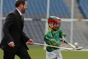 30 March 2004; McDonald's Restaurants of Ireland and the GAA today launched an innovative campaign to improve the hurling and camogie skills of thousands of primary school children across Ireland. Pictured at the launch is 8 year old James Tyrrell, Dublin, in action against GAA President Sean Kelly. Croke Park, Dublin. Picture credit; David Maher / SPORTSFILE *EDI*