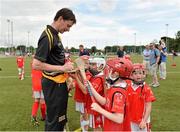 27 July 2013; Kildare footballer John Doyle and former Kilkenny hurler Martin Comerford supporting the Opel Kit for Clubs Blitz Day in St. Brigids GAA Club, Blanchardstown. Former Kilkenny hurler Martin Comerford signs autographs for children from St. Brigids GAA Club, Blanchardstown, during a skills session. For every test drive, car service or Opel purchase made through the Opel dealer network, your local GAA club is awarded points. Build up your points and redeem them against high quality kit for your club! Log onto opelkitforclubs.com http://opelkitforclubs.com and start earning points today.  Support your local GAA club! St. Brigid's GAA Club, Blanchardstown, Dublin. Picture credit: Barry Cregg / SPORTSFILE