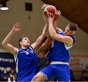 22 January 2022; Toby Christensen, left, and Kevin Moynihan of UCC Demons claim a rebound ahead of Steven Safo of Drogheda Wolves during the InsureMyHouse.ie Presidents' National Cup Final match between UCC Demons, Cork, and Drogheda Wolves, Louth, at National Basketball Arena in Tallaght, Dublin. Photo by Brendan Moran/Sportsfile