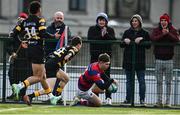 19 February 2022; Tadhg Bird of Clontarf scores his side's first try despite the efforts of Evan Cusack of Young Munster during the Energia All-Ireland League Division 1A match between Clontarf and Young Munster at Castle Avenue in Dublin. Photo by Sam Barnes/Sportsfile