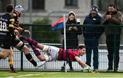 19 February 2022; Adrian D'Arcy of Clontarf dives over to score his side's third try during the Energia All-Ireland League Division 1A match between Clontarf and Young Munster at Castle Avenue in Dublin. Photo by Sam Barnes/Sportsfile