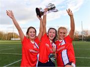 11 March 2022; MTU players, from left, Caitlin Duffy, Emma Barry and Meave Daly of MTU celebrate with the Moynihan Cup after their victory in the Yoplait LGFA Moynihan Cup Final match between Letterkenny IT, Donegal, and MTU, Cork, at DCU Dóchas Éireann Astro Pitch in Dublin. Photo by Sam Barnes/Sportsfile