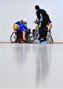 12 March 2022; Players contest possession as referee Maggie Farrelly keeps watch during the GAA National Wheelchair Hurling/Camogie Interprovincial leagues match between Munster and Connacht at Omagh Leisure Centre in Omagh, Tyrone. Photo by Ben McShane/Sportsfile