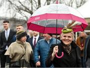 16 March 2022; A racegoer arrives under an umbrella ahead of racing on day two of the Cheltenham Racing Festival at Prestbury Park in Cheltenham, England. Photo by Seb Daly/Sportsfile
