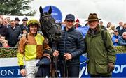 17 April 2022; Jockey Paul Townend, groom Adam Connolly and trainer Willie Mullins with Galopin Des Champs after victory in the BoyleSports Gold Cup Novice Steeplechase during day two of the Fairyhouse Easter Festival at the Fairyhouse Racecourse in Ratoath, Meath. Photo by Seb Daly/Sportsfile