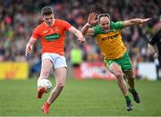 24 April 2022; Jarly Óg Burns of Armagh under pressure from Michael Murphy of Donegal during the Ulster GAA Football Senior Championship Quarter-Final match between Donegal and Armagh at Páirc MacCumhaill in Ballybofey, Donegal. Photo by Ramsey Cardy/Sportsfile