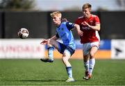 26 April 2022; Matthew Scott of UCD in action against Ronan Young of Queen's University Belfast during the Collingwood Cup Final match between UCD and Queens University Belfast at Oriel Park in Dundalk, Louth. Photo by Ben McShane/Sportsfile