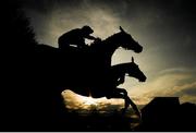 27 April 2022; Cavalry Master, top, with Rachael Blackmore up, and The West's Awake, bottom, with Phillip Enright up, jump the last during the first circuit of the OMC Claims Handicap Steeplechase during day two of the Punchestown Festival at Punchestown Racecourse in Kildare. Photo by Seb Daly/Sportsfile