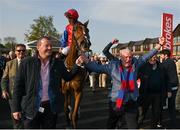 27 April 2022; Owners Ger O'Brien, left, and Sean Deane celebrate as they lead in jockey Patrick Mullins and Facile Vega after winning the Race & Stay At Punchestown Champion INH Flat Race during day two of the Punchestown Festival at Punchestown Racecourse in Kildare. Photo by Seb Daly/Sportsfile