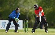 10 May 2022; Tyrone Kane of Munster Reds plays a shot watched by Leinster Lightning wicket keeper Lorcan Tucker during the Cricket Ireland Inter-Provincial Cup match between Leinster Lightning and Munster Reds at Pembroke Cricket Club in Dublin. Photo by Sam Barnes/Sportsfile