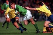 21 November 1998: Jonathan Bell of Ireland is tackled by Dvidiu Slusariuc, right, and Alexandru Manta of Romania.  during the World Cup Qualifing match between Ireland and Romania at Lansdowne Road in Dublin. Photo by David Maher/Sportsfile
