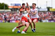 5 June 2022; Michael McKernan of Tyrone is tackled by Aidan Nugent of Armagh during the GAA Football All-Ireland Senior Championship Round 1 match between Armagh and Tyrone at Athletic Grounds in Armagh. Photo by Ben McShane/Sportsfile