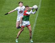 12 June 2022; Rio Mortimer of Mayo in action against Eoin Cully of Kildare during the Electric Ireland GAA Football All-Ireland Minor Championship Quarter-Final match between Mayo and Kildare at O'Connor Park in Tullamore, Offaly. Photo by Piaras Ó Mídheach/Sportsfile