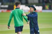 26 June 2022; Ireland head coach Heinrich Malan, right, and Mark Adair before the LevelUp11 First Men's T20 International match between Ireland and India at Malahide Cricket Club in Dublin. Photo by Ramsey Cardy/Sportsfile