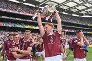 9 July 2022; Ronan Wallace of Westmeath celebrates with the trophy and teammates after their side's victory in the Tailteann Cup Final match between Cavan and Westmeath at Croke Park in Dublin. Photo by Seb Daly/Sportsfile