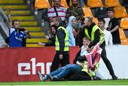 14 July 2022; A supporter is removed from the pitch during the UEFA Europa Conference League 2022/23 First Qualifying Round Second Leg match between Riga and Derry City at the Skonto Stadium in Riga, Latvia. Photo by Roman Koksarov/Sportsfile