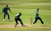 15 July 2022; Curtis Campher of Ireland attempts to run out Tom Latham of New Zealand during the Men's One Day International match between Ireland and New Zealand at Malahide Cricket Club in Dublin. Photo by Seb Daly/Sportsfile