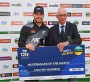 18 July 2022; Glenn Phillips of New Zealand is presented with his Multibagger of the Match cheque by Cricket Ireland president David Griffin after the Men's T20 International match between Ireland and New Zealand at Stormont in Belfast. Photo by Ramsey Cardy/Sportsfile