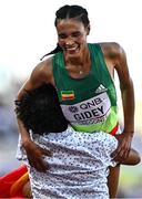 23 July 2022; Letesenbet Gidey of Ethiopia is lifted up by a spectator who ran on to the track after the women's 5000m final during day nine of the World Athletics Championships at Hayward Field in Eugene, Oregon, USA. Photo by Sam Barnes/Sportsfile