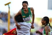 23 July 2022; Letesenbet Gidey of Ethiopia is lifted up by a spectator who ran on to the track after the women's 5000m final during day nine of the World Athletics Championships at Hayward Field in Eugene, Oregon, USA. Photo by Sam Barnes/Sportsfile