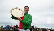 25 July 2022; Patrick Mullins with the plate after riding Echoes In Rain to win the Connacht Hotel Handicap during day one of the Galway Races Summer Festival at Ballybrit Racecourse in Galway. Photo by Harry Murphy/Sportsfile
