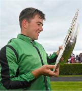 27 July 2022; Jockey Jordan Gainford with the trophy after winning the Tote Galway Plate on Hewick during day three of the Galway Races Summer Festival at Ballybrit Racecourse in Galway. Photo by Seb Daly/Sportsfile