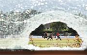 28 July 2022; A general view through a broken window as Fionn Hand of Munster Reds plays a shot watched by Northern Knights wicketkeeper Neil Rock during the Cricket Ireland Inter-Provincial Trophy match between Munster Reds and Northern Knights at Pembroke Cricket Club in Dublin. Photo by Sam Barnes/Sportsfile