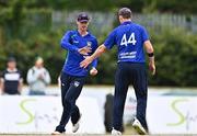 28 July 2022; Graham Kennedy of North West Warriors, left, celebrates with team-mate Craig Young after catching out Simi Singh of Leinster Lightning during the Cricket Ireland Inter-Provincial Trophy match between Leinster Lightning and North West Warriors at Pembroke Cricket Club in Dublin. Photo by Sam Barnes/Sportsfile