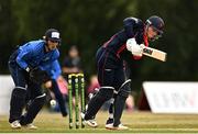 29 July 2022; Neil Rock of Northern Knights plays a shot watched by Leinster Lightning wicketkeeper Lorcan Tucker during the Cricket Ireland Inter-Provincial Trophy match between Northern Knights and Leinster Lightning at Pembroke Cricket Club in Dublin. Photo by Sam Barnes/Sportsfile
