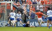 23 May 2004; Ronan Clarke, 14, Armagh, shoots to score his sides second goal despite the attentions of Monaghan goalkeeper Glenn Murphy. Bank of Ireland Ulster Senior Football Championship, Monaghan v Armagh, St. Tighernach's Park, Clones, Co. Monaghan. Picture credit; Damien Eagers / SPORTSFILE