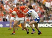 23 May 2004; Tony McEntee, Armagh, is tackled by Dermot Duffy, Monaghan. Bank of Ireland Ulster Senior Football Championship, Monaghan v Armagh, St. Tighernach's Park, Clones, Co. Monaghan. Picture credit; Pat Murphy / SPORTSFILE