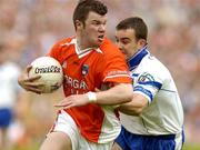 23 May 2004; Ronan Clarke, Armagh, in action against John Paul Mone, Monaghan. Bank of Ireland Ulster Senior Football Championship, Monaghan v Armagh, St. Tighernach's Park, Clones, Co. Monaghan. Picture credit; Pat Murphy / SPORTSFILE