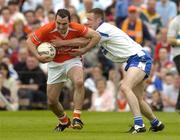 23 May 2004; Martin O'Rourke, Armagh, is tackled by Vincent Corey, Monaghan. Bank of Ireland Ulster Senior Football Championship, Monaghan v Armagh, St. Tighernach's Park, Clones, Co. Monaghan. Picture credit; Pat Murphy / SPORTSFILE