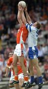 23 May 2004; Eoin Lennon, Monaghan, goes up for a high ball with Philip Loughran, Armagh. Bank of Ireland Ulster Senior Football Championship, Monaghan v Armagh, St. Tighernach's Park, Clones, Co. Monaghan. Picture credit; Damien Eagers / SPORTSFILE