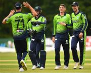15 August 2022; Ireland players, from left, Fionn Hand, Lorcan Tucker, Gareth Delany and George Dockrell celebrate dismissing Hazratuillah Zazai of Afghanistan during the Men's T20 International match between Ireland and Afghanistan at Stormont in Belfast. Photo by Ramsey Cardy/Sportsfile