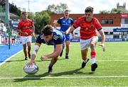 20 August 2022; Conor Moore of Leinster scores a try, despite the efforts of Mason Cawley of Munster, during the U18 Clubs Interprovincial Series 2022 match between Leinster and Munster at Energia Park in Dublin. Photo by Piaras Ó Mídheach/Sportsfile