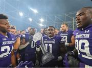 27 August 2022; Northwestern Wildcats running back Andrew Clair celebrates with the trophy alongside his teammates after their side's victory in the Aer Lingus College Football Classic 2022 match between Northwestern Wildcats and Nebraska Cornhuskers at Aviva Stadium in Dublin. Photo by Brendan Moran/Sportsfile