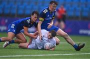 3 September 2022; David Armstrong of Ulster on his way to scoring his side's second try, despite the tackle of Sean Finlay, left, and Harry Roche Nagle of Leinster during the U18 Schools Age-Grade Interprovincial Series match between Leinster and Ulster at Energia Park in Dublin. Photo by Ben McShane/Sportsfile