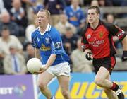 30 May 2004; Jason O'Reilly puts over a late point, to give Cavan the lead, despite the attention of Brendan Grant, Down. Bank of Ireland Ulster Senior Football Championship Replay, Cavan v Down, Kingspan Breffni Park, Co. Cavan. Picture credit; Matt Browne / SPORTSFILE