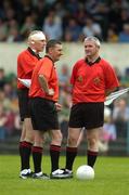 23 May 2004; Referee Gerry Kinneavy, left, alongside linesmen Michael Walsh, centre, and Haulie Byrne, await the start of the second half. Kinneavy had his head bandaged after receiving 3 stitches after an accidental clash with Clare's Ger Quinlan. Bank of Ireland Munster Senior Football Championship, Clare v Kerry, Cusack Park, Ennis, Co. Clare. Picture credit; Brendan Moran / SPORTSFILE