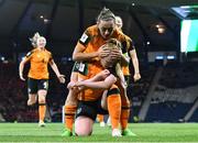 11 October 2022; Amber Barrett of Republic of Ireland, bottom, celebrates with teammates Katie McCabe after scoring their side's first goal by kissing the black armband worn to remember the lives lost and those injured in the Creeslough tragedy in Donegal during the FIFA Women's World Cup 2023 Play-off match between Scotland and Republic of Ireland at Hampden Park in Glasgow, Scotland. Photo by Mick O'Shea/Sportsfile