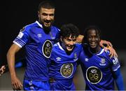 26 October 2022; Phoenix Patterson of Waterford celebrates with teammates Wassim Aouachria, left, and Junior Quitirna after scoring their side's second goal during the SSE Airtricity League First Division play-off semi-final first leg match between Treaty United and Waterford at Markets Field in Limerick. Photo by Seb Daly/Sportsfile
