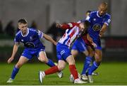 26 October 2022; Willie Armshaw of Treaty United in action against Darragh Power, left, and Alex Baptiste of Waterford during the SSE Airtricity League First Division play-off semi-final first leg match between Treaty United and Waterford at Markets Field in Limerick. Photo by Seb Daly/Sportsfile