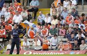 23 May 2004; Monaghan manager Colm Coyle looks on as Armagh supporters celebrate their second goal. Bank of Ireland Ulster Senior Football Championship, Monaghan v Armagh, St. Tighernach's Park, Clones, Co. Monaghan. Picture credit; Damien Eagers / SPORTSFILE