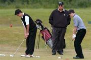 1 June 2004; World leading golf coach Butch Harmon watches over Gary McMcGrane, left, Royal Dublin golf club, and Thomas McIntyre, Ballyclare Golf Club, Co. Antrim, at the Red Bull masterclass. Portmarnock Golf Club, Portmarnock, Co. Dublin. Picture credit; David Maher / SPORTSFILE