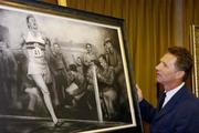 3 June 2004; Former Irish athlete Eamonn Coghlan admires a framed charcoal drawing of the famous moment when athlete Roger Bannister became the first person to run a mile in under four minutes. The Westbury Hotel, Dublin. Picture credit; Brian Lawless / SPORTSFILE