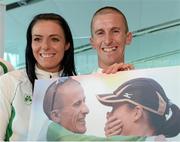 16 August 2013; Men's 50km gold medal winner Robert Heffernan and his wife Marian, after being presented with a photograph, in Dublin airport on his return from the IAAF World Athletics Championships in Moscow. Dublin Airport, Dublin. Picture credit: Brian Lawless / SPORTSFILE